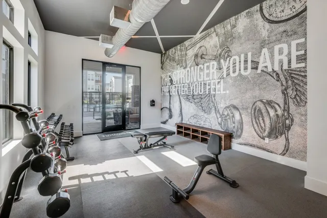 a bedroom with a bed and a wall painting