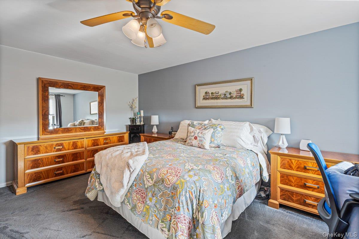 18-55 Corporal Kennedy Street, Unit 6H Queens, NY 11360 - Photo 11 of 18 Carpeted bedroom with a ceiling fan