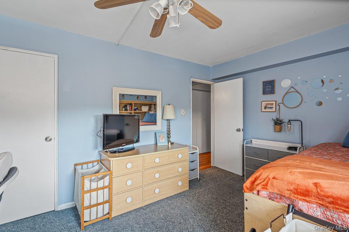 18-55 Corporal Kennedy Street, Unit 6H Queens, NY 11360 - Photo 14 of 18 Bedroom featuring dark colored carpet and ceiling fan