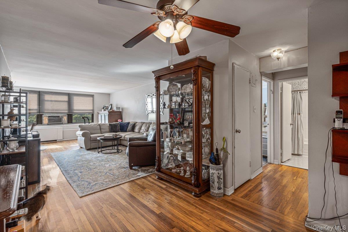 18-55 Corporal Kennedy Street, Unit 6H Queens, NY 11360 - Photo 7 of 18 Living area with ceiling fan and wood finished floors