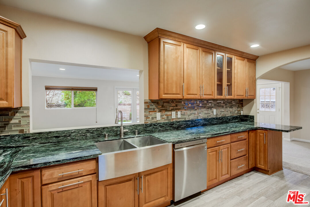 23620 Sunset Crossing Road Diamond Bar, CA 91765 - Photo 21 of 41 a kitchen with stainless steel appliances granite countertop a sink a stove cabinets and a counter top space