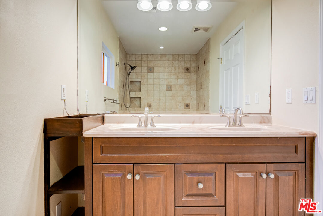23620 Sunset Crossing Road Diamond Bar, CA 91765 - Photo 32 of 41 a bathroom with a sink vanity and a mirror