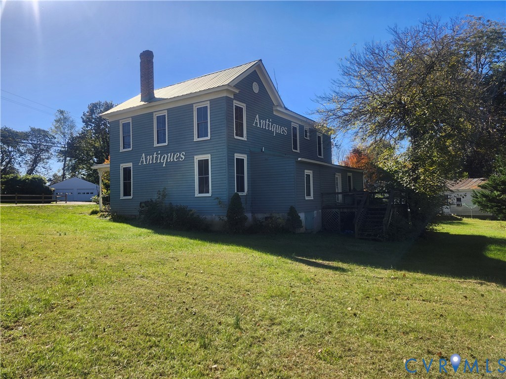 25 Fitzgerald Road Cumberland, VA 23040 - Photo 2 of 19 View of side of home with a chimney, a lawn, a woo