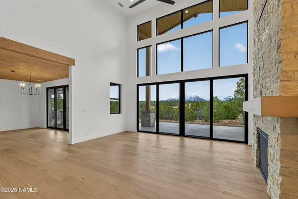 a view of an empty room with furniture and a fireplace