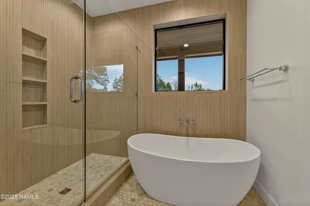 a bathroom with a tub and shower