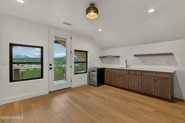 a view of staircase with wooden floor and fan