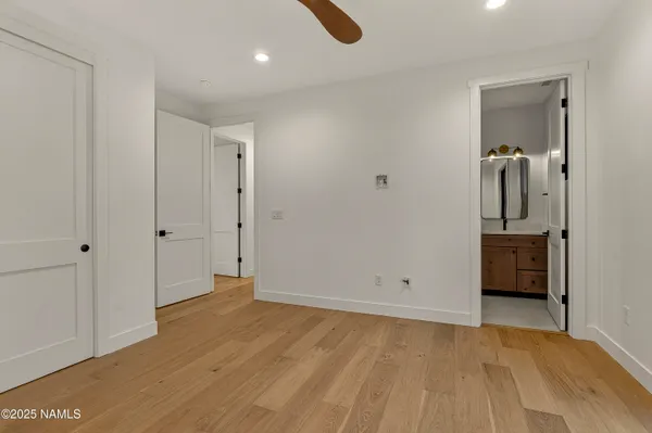 a bathroom with a granite countertop toilet sink and mirror