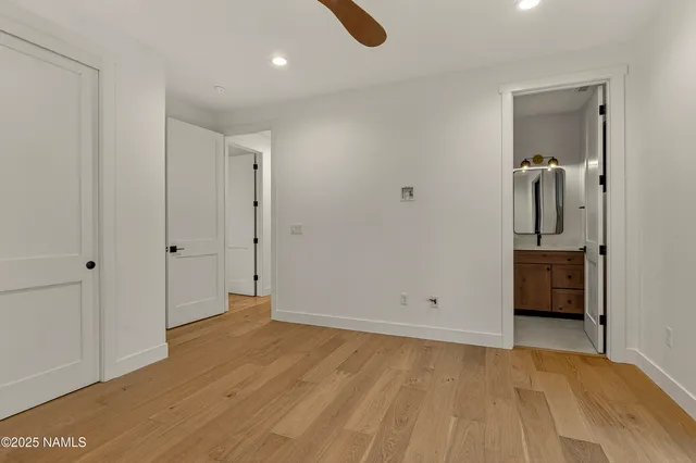 a bathroom with a granite countertop toilet sink and mirror