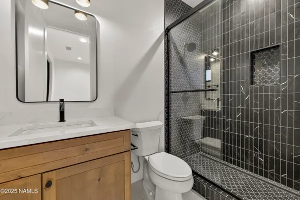 a view of an empty room with closet and a window