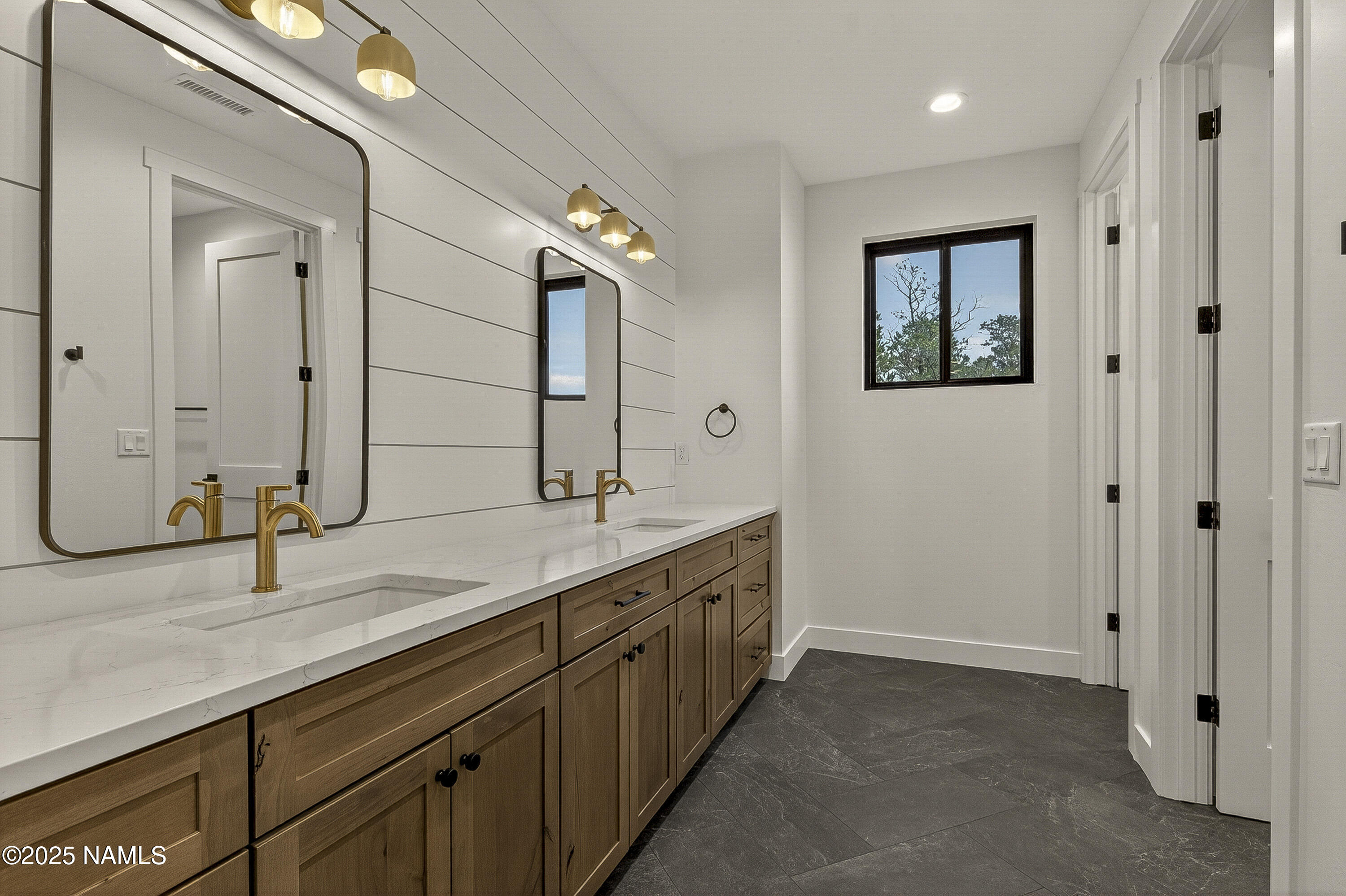 8488 Tall Tales Rnch Road Flagstaff, AZ 86004 - Photo 33 of 52 a bathroom with a double vanity sink and a mirror