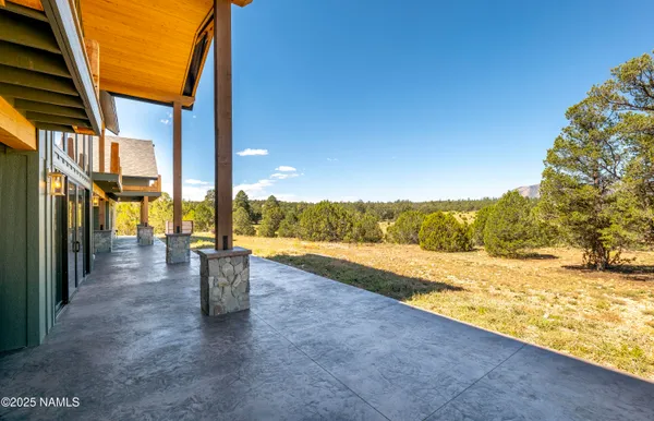 an aerial view of a house with swimming pool garden and patio