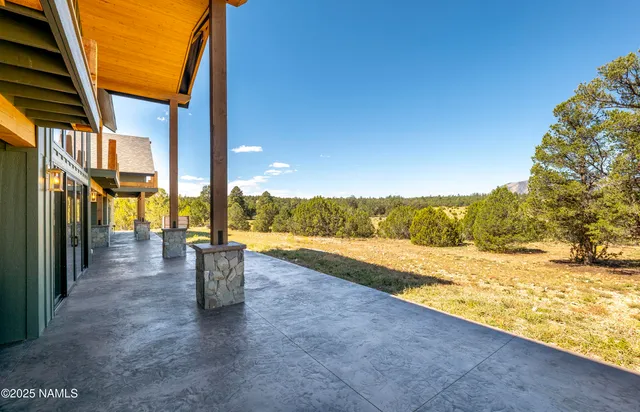 an aerial view of a house with swimming pool garden and patio