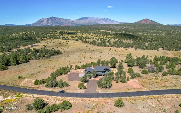 an aerial view of a house with a big yard