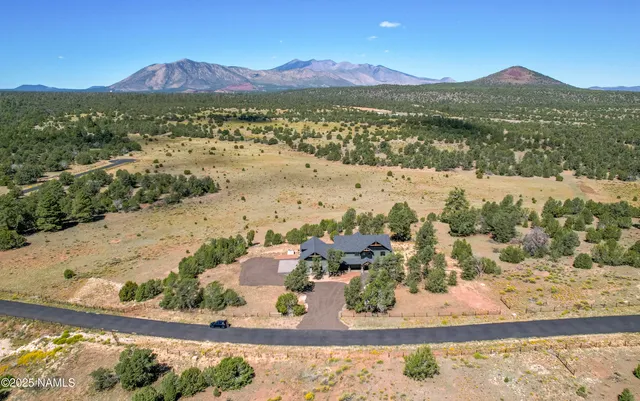 an aerial view of a house with a big yard