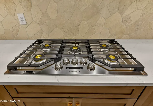a view of an empty room with a fireplace and a window