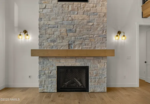 a view of an empty room with a fireplace and a window