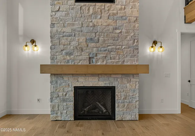 a view of an empty room with a fireplace and a window