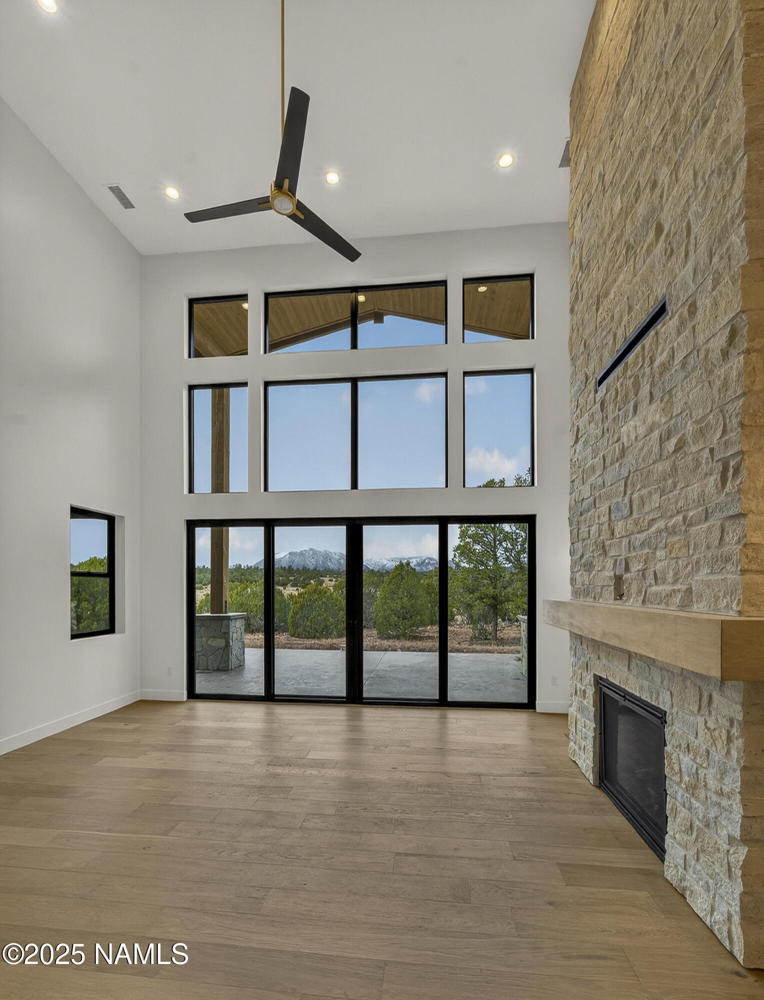 8488 Tall Tales Rnch Road Flagstaff, AZ 86004 - Photo 10 of 52 a view of an empty room with a fireplace and a window