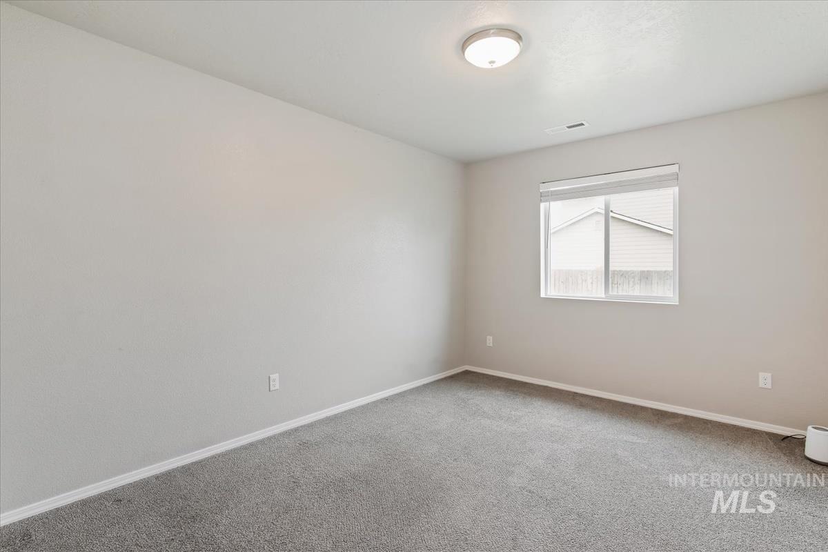 1685 Southwest Levant Way Mountain Home, ID 83647 - Photo 17 of 31 Carpeted empty room featuring baseboards