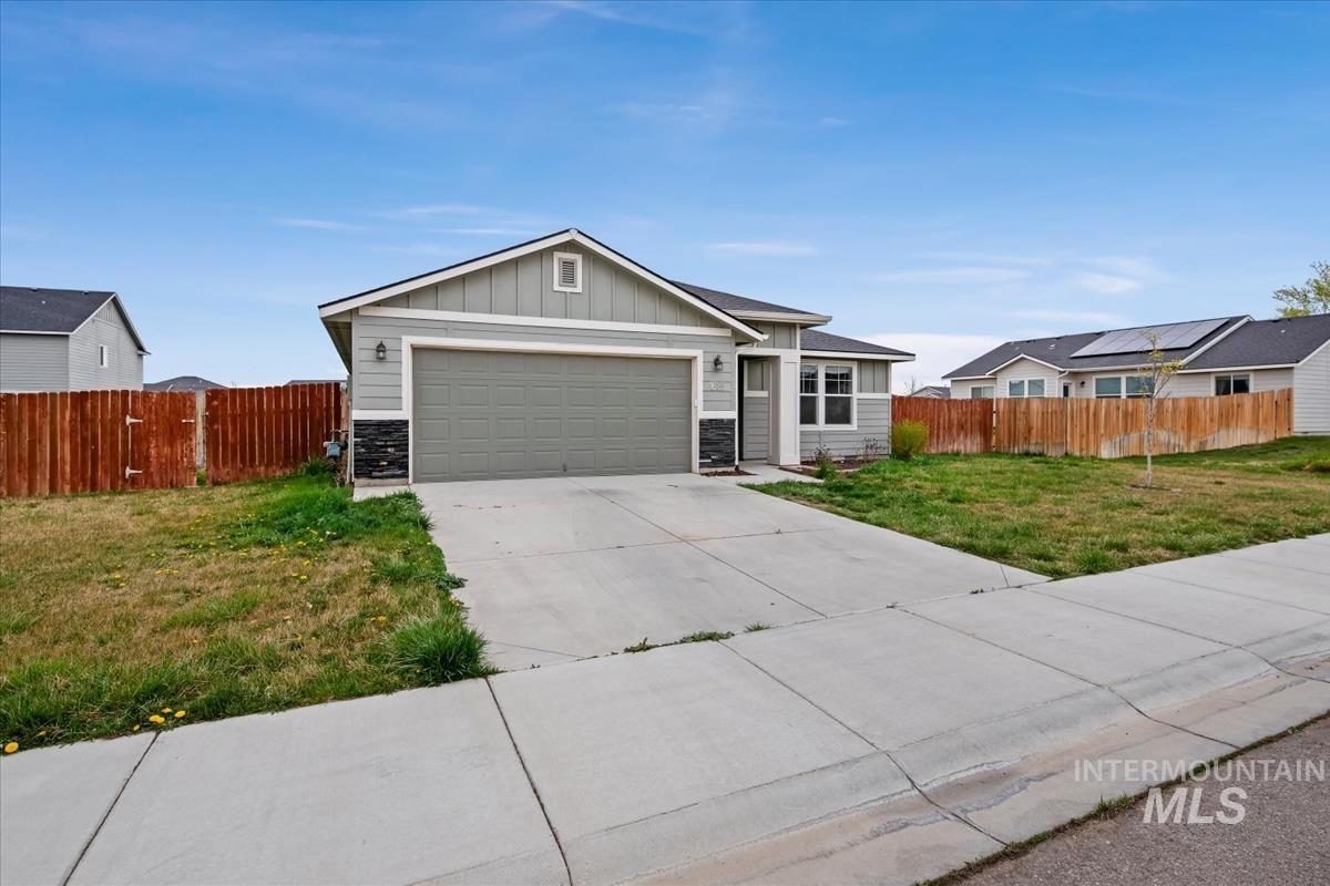 1685 Southwest Levant Way Mountain Home, ID 83647 - Photo 2 of 31 Ranch-style house featuring board and batten siding, stone siding, concrete driveway, and an attached garage
