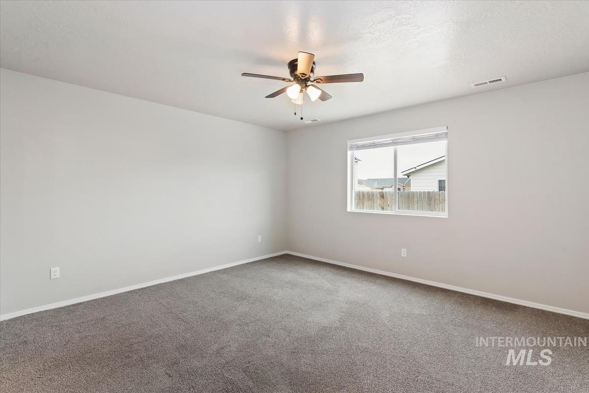 1685 Southwest Levant Way Mountain Home, ID 83647 - Photo 20 of 31 Spare room with ceiling fan and carpet floors