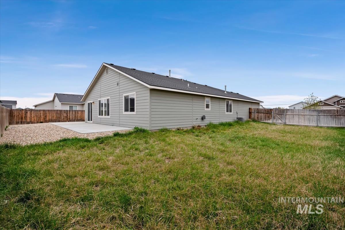 1685 Southwest Levant Way Mountain Home, ID 83647 - Photo 26 of 31 Rear view of property featuring a patio and a fenced backyard