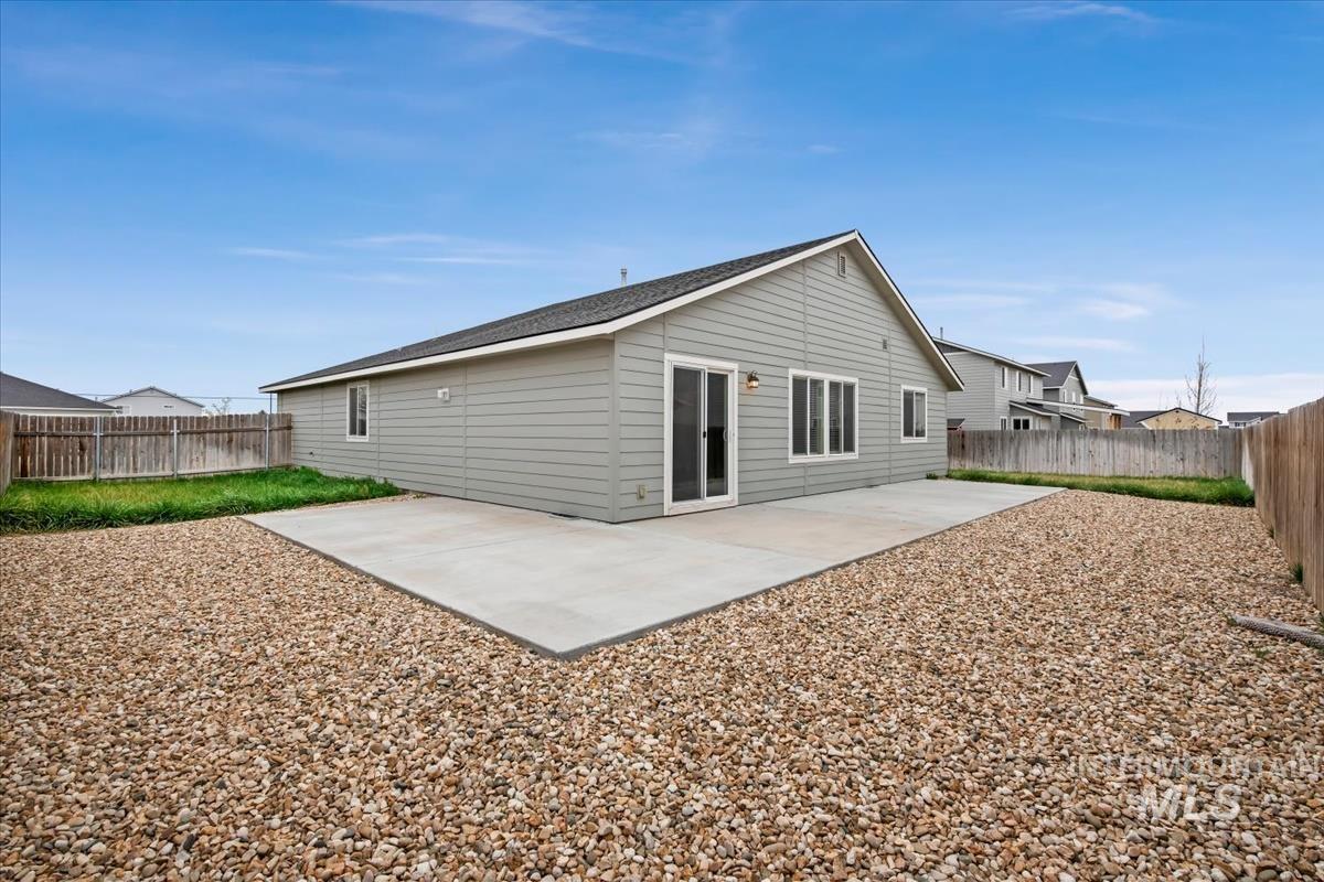 1685 Southwest Levant Way Mountain Home, ID 83647 - Photo 29 of 31 Back of house with a patio area and a fenced backyard