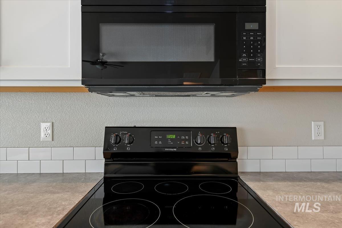 1685 Southwest Levant Way Mountain Home, ID 83647 - Photo 10 of 31 Kitchen view of black appliances and white cabinets
