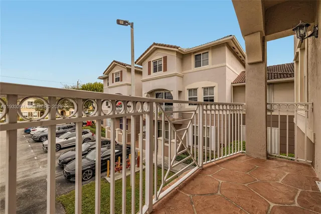a view of a balcony and car parked