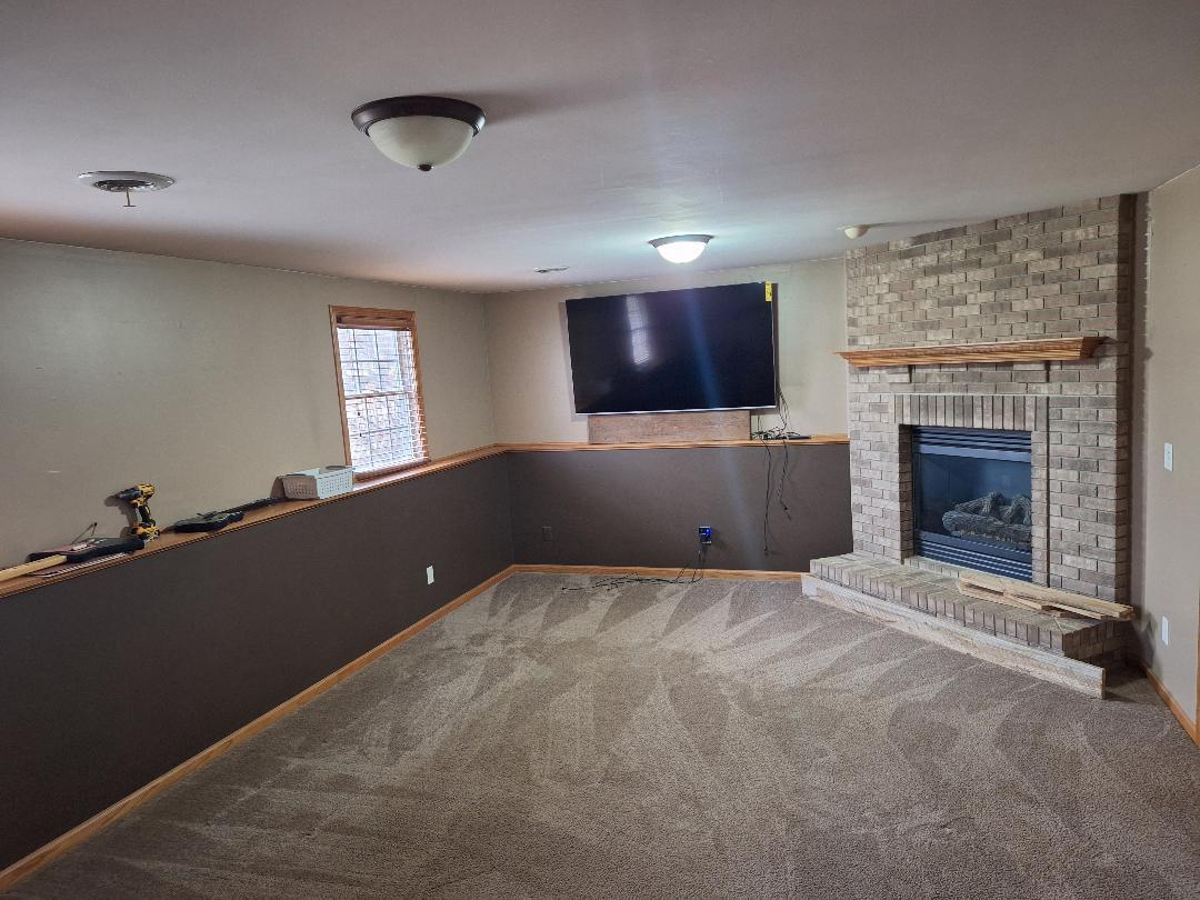 602 Sandra Street Kingston, IL 60145 - Photo 11 of 18 a living room with a fireplace and a flat screen tv