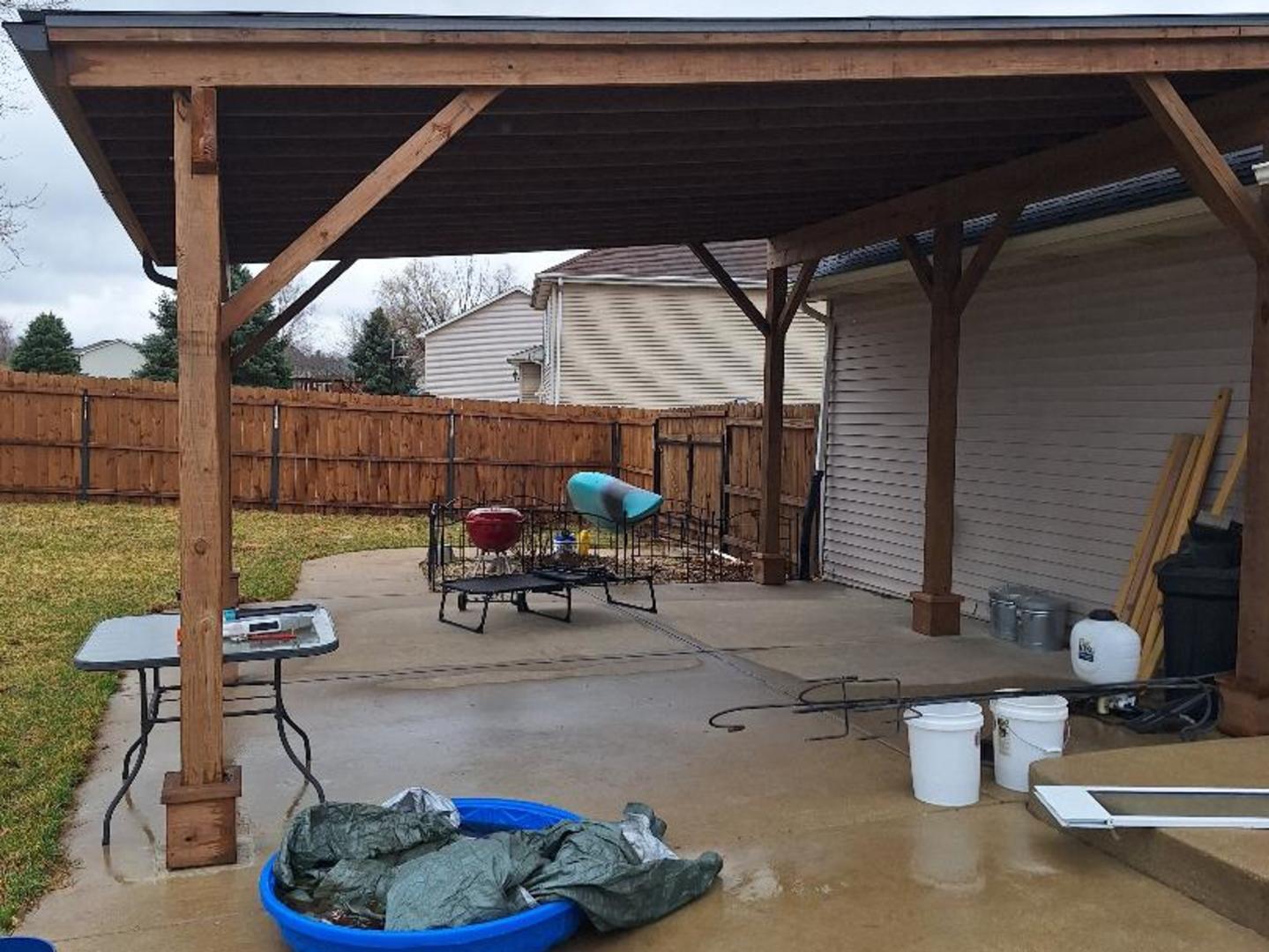 602 Sandra Street Kingston, IL 60145 - Photo 15 of 18 a view of a patio with table and chairs potted plants
