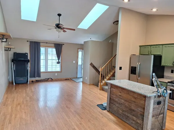 a view of an empty room with a ceiling fan