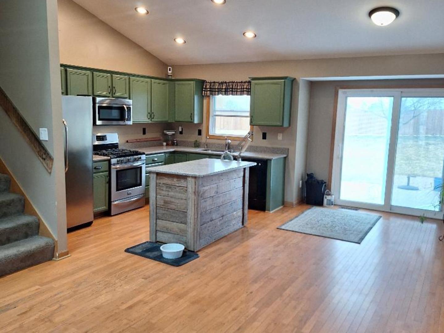 602 Sandra Street Kingston, IL 60145 - Photo 3 of 18 a kitchen with stainless steel appliances granite countertop a stove top oven a sink dishwasher a refrigerator and a fireplace