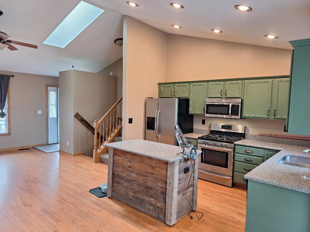 602 Sandra Street Kingston, IL 60145 - Photo 3 of 9 a kitchen with stainless steel appliances kitchen island granite countertop a stove a refrigerator and a microwave