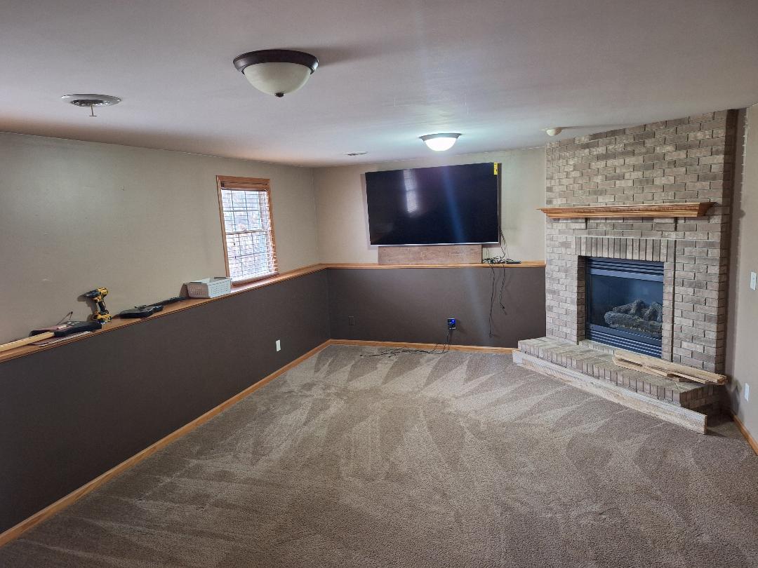 602 Sandra Street Kingston, IL 60145 - Photo 6 of 9 a living room with a fireplace and a flat screen tv