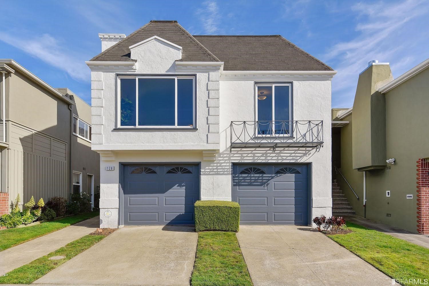 a front view of a house with a garden