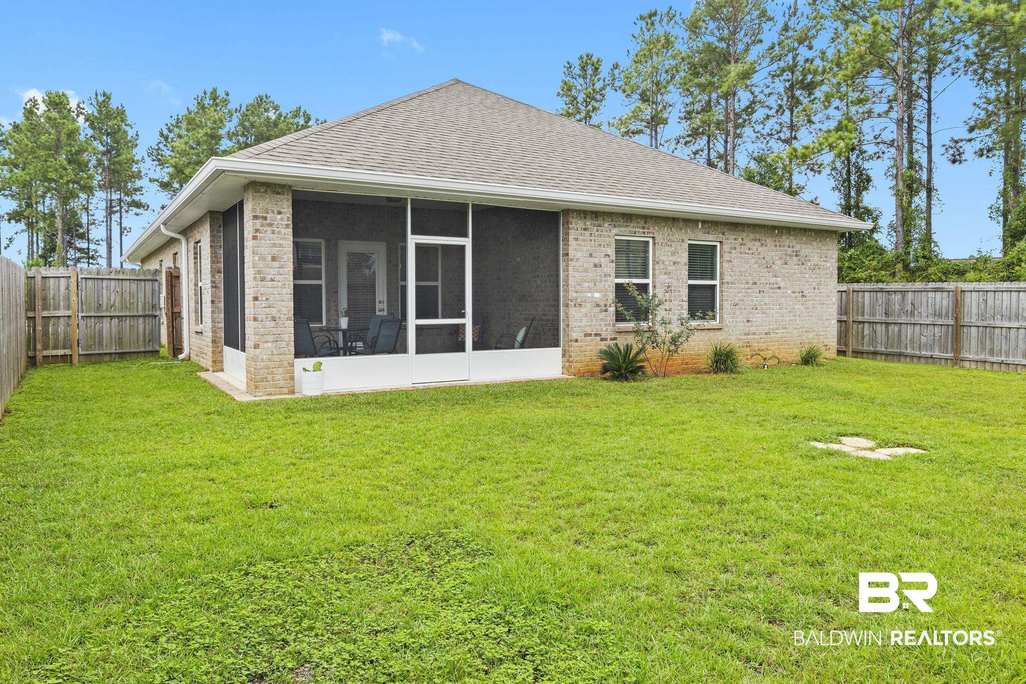 31643 Kestrel Loop Daphne, AL 36527 - Photo 37 of 59 Rear view of house with a sunroom and a lawn