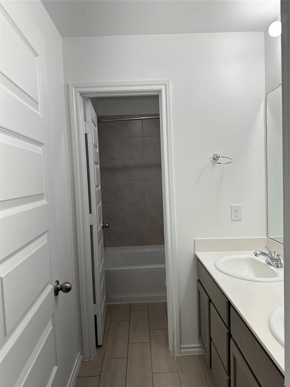 3004 Baneberry Lane, Unit 43 Mesquite, TX 75150 - Photo 11 of 16 a bathroom with a sink and a mirror