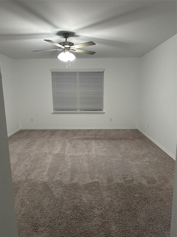 3004 Baneberry Lane, Unit 43 Mesquite, TX 75150 - Photo 13 of 16 a view of an empty room with a chandelier fan