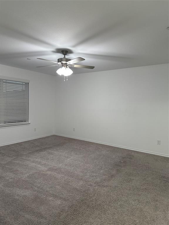 3004 Baneberry Lane, Unit 43 Mesquite, TX 75150 - Photo 14 of 16 an empty room with chandelier fan and windows