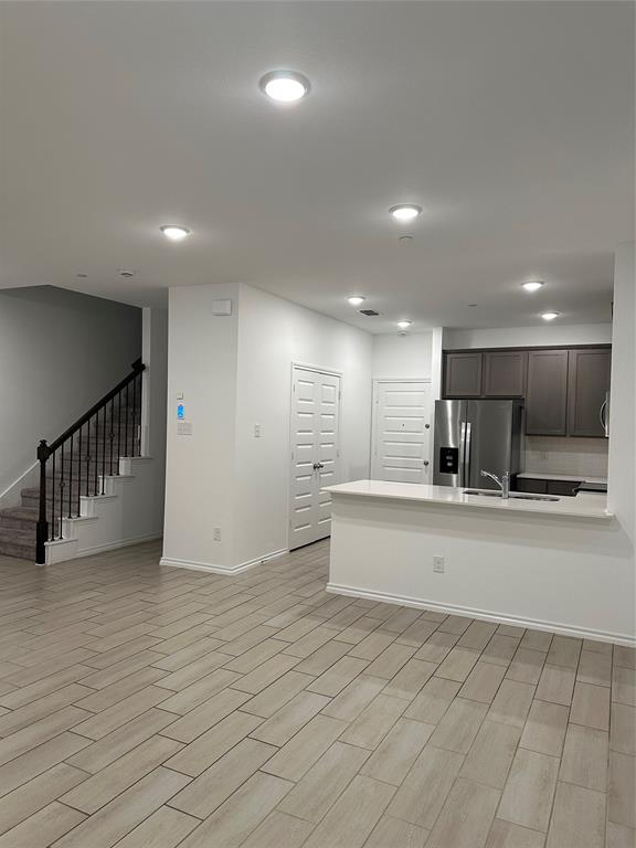 3004 Baneberry Lane, Unit 43 Mesquite, TX 75150 - Photo 6 of 16 a view of an empty room and kitchen with furniture