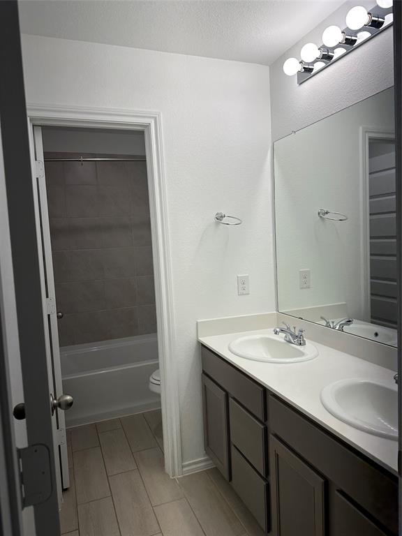 3004 Baneberry Lane, Unit 43 Mesquite, TX 75150 - Photo 10 of 16 a bathroom with a sink double vanity and a mirror