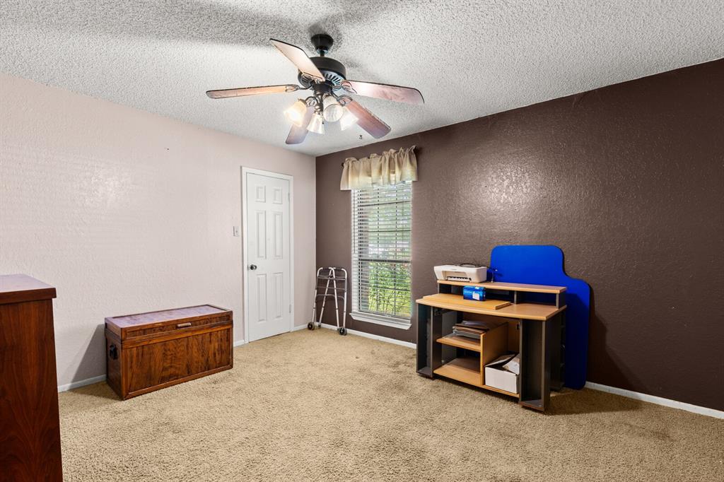 1502 Hinchliffe Road Mexia, TX 76667 - Photo 12 of 40 Office space with a textured wall, carpet floors, a textured ceiling, and ceiling fan