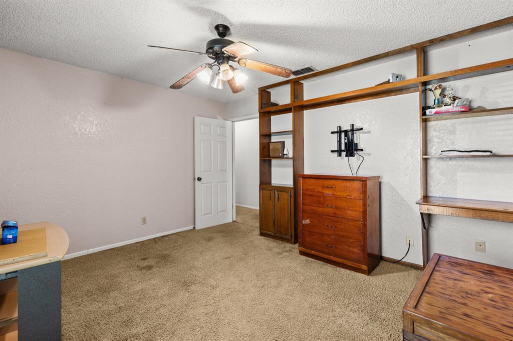 1502 Hinchliffe Road Mexia, TX 76667 - Photo 13 of 40 Unfurnished bedroom featuring light carpet, baseboards, visible vents, and a textured ceiling