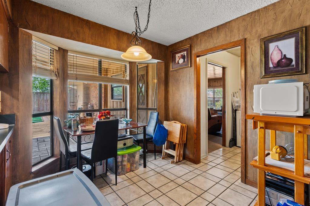 1502 Hinchliffe Road Mexia, TX 76667 - Photo 23 of 40 Dining room featuring a textured ceiling and light tile patterned floors