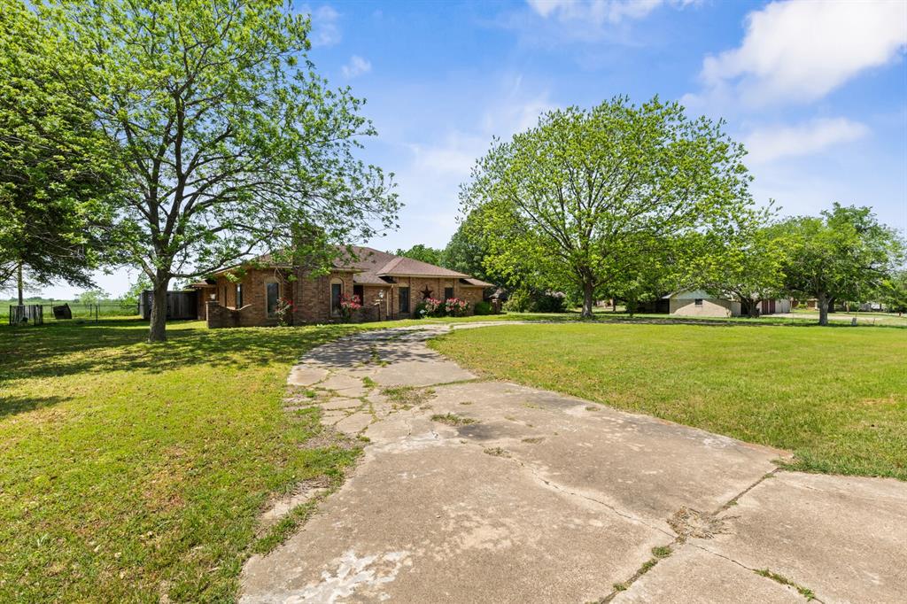 1502 Hinchliffe Road Mexia, TX 76667 - Photo 5 of 40 Ranch-style house featuring a front lawn and brick siding