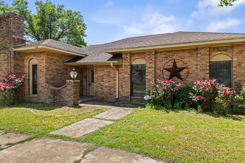 1502 Hinchliffe Road Mexia, TX 76667 - Photo 7 of 40 View of front of house featuring brick siding, a shingled roof, and a front yard