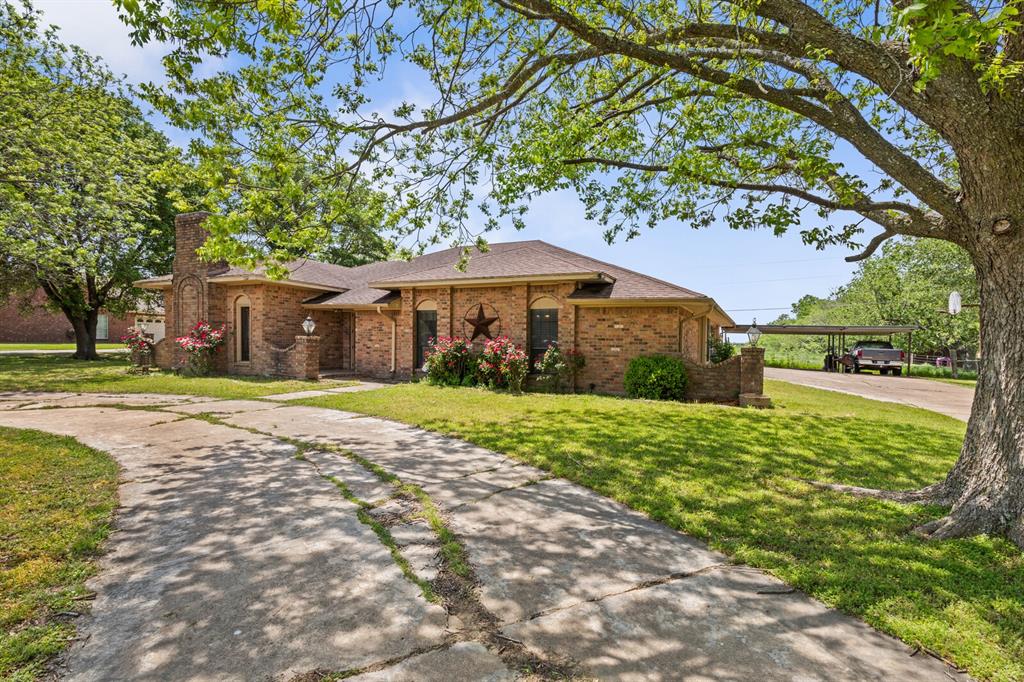 1502 Hinchliffe Road Mexia, TX 76667 - Photo 8 of 40 Single story home with brick siding, driveway, roof with shingles, and a front yard