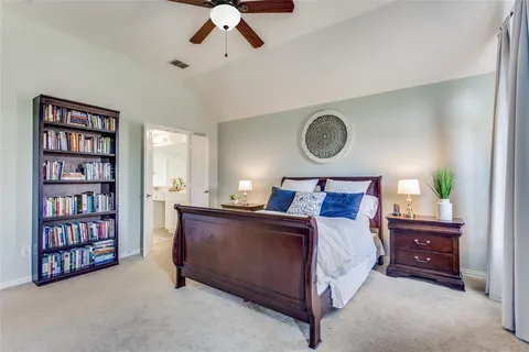 a bed room with a bed and a book shelf