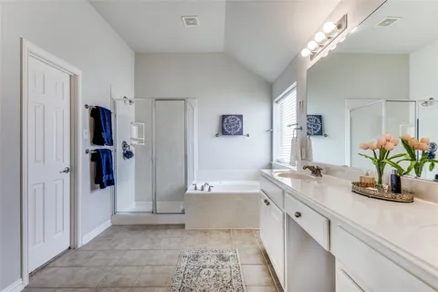 a bathroom with a tub sink and mirror